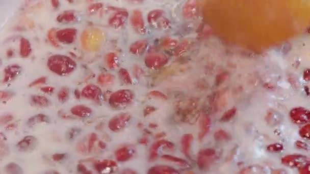 Wooden Spoon Stirring Boiling Domestic Cherry Jam Full Frame Closeup — Stockvideo