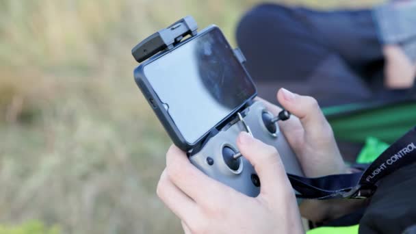 Drone Operator Hands Using Remote Control Sticks Cellphone Monitor Daylight — Videoclip de stoc