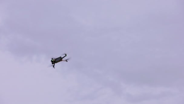 Small Modern Civilian Quadcopter Drone Maneuvering Cloudy Sky View Ground — Video