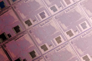 Silicon monocrystalline wafer with microchips after photolithography etching manufacturing used in fabrication of electronic integrated circuits. Full-frame high-tech macro background.