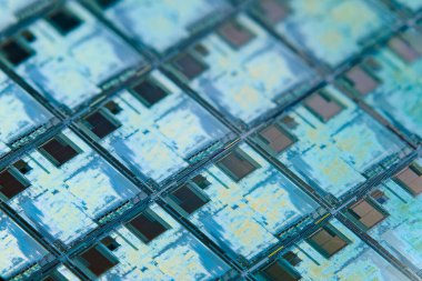 Silicon monocrystalline wafer with microchips after photolithography etching manufacturing used in fabrication of electronic integrated circuits. Full-frame high-tech macro background.