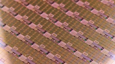 full-frame looped spinning silicone microchip wafer with gold colored chips, real-lofe video footage