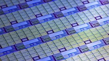full-frame looped spinning silicone microchip wafer with gold and blue colored chips, real-lofe video footage