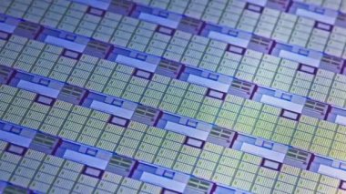 full-frame looped spinning silicone microchip wafer with gold and blue colored chips, real-lofe video footage