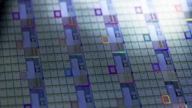 full-frame looped spinning silicone microchip wafer with gold and blue colored chips, real-lofe video footage