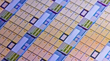 full-frame looped spinning silicone microchip wafer with gold and blue colored chips, real-lofe video footage