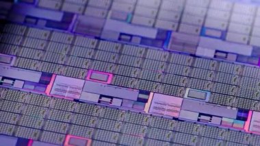 full-frame looped spinning silicone microchip wafer with gold and blue colored chips, real-lofe video footage