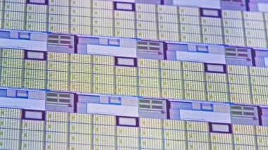 full-frame looped spinning silicone microchip wafer with gold and blue colored chips, real-lofe video footage