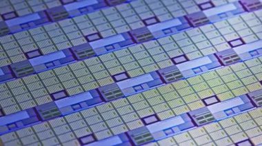 full-frame looped spinning silicone microchip wafer with gold and blue colored chips, real-lofe video footage