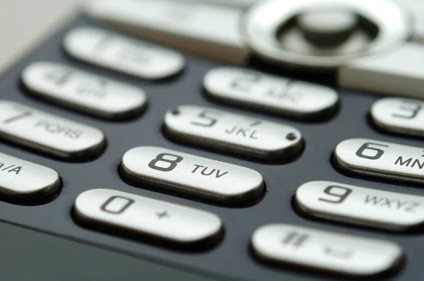 Um close-up de teclado móvel sob a luz — Fotografia de Stock