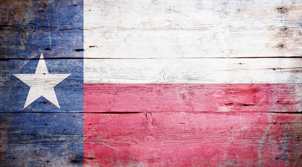 Flag of the State of Texas painted on grungy wooden background