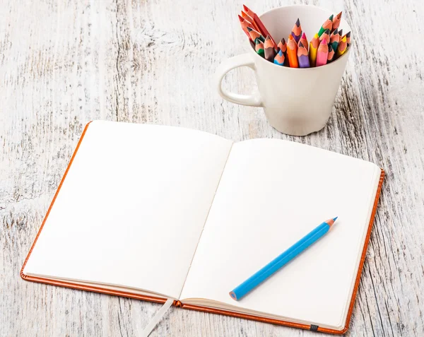 Colorful pencils and notebook Stock Photo