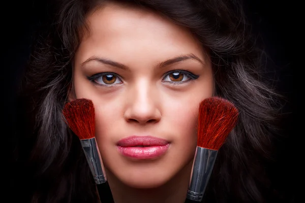 Girl with makeup brushes — Stock Photo, Image