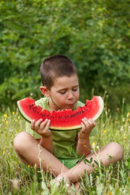 Boy eating watermelon