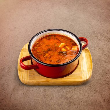 Pot of Hungarian goulash on brown background