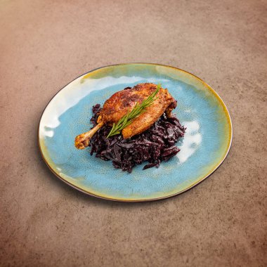 Grilled confit duck legs served with braised red cabbage
