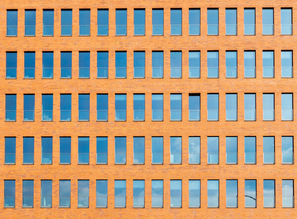 Background from an orange brickwall with a lot of windows