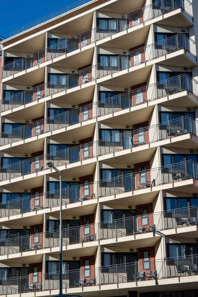 High-rise apartment building with many small balconies seen in Barcelona, Spain