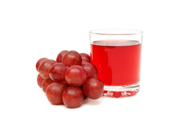 Стекло с соком и виноградом — стоковое фото