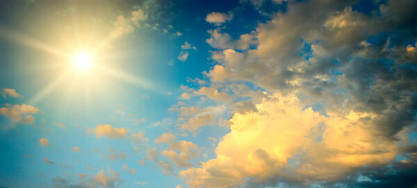 Panoramic epic sky landscape with bright sun and fantastically beautiful clouds.
