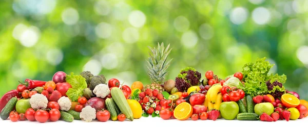 Collage fresh colored vegetables, fruits, berries on green background. Healthy food concept