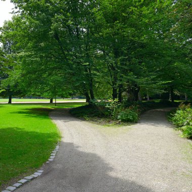 Gravel path for sports and walking in public summer park.