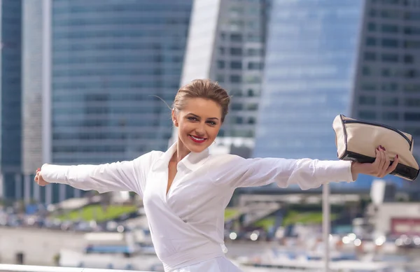 Young female businesswoman Carefullyenjoys success on the background a modern business center — Stock Photo, Image