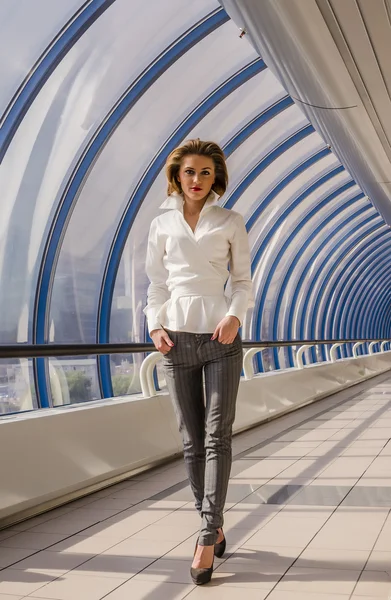 Young female businesswoman Carefully on the background a modern business center — Stock Photo, Image