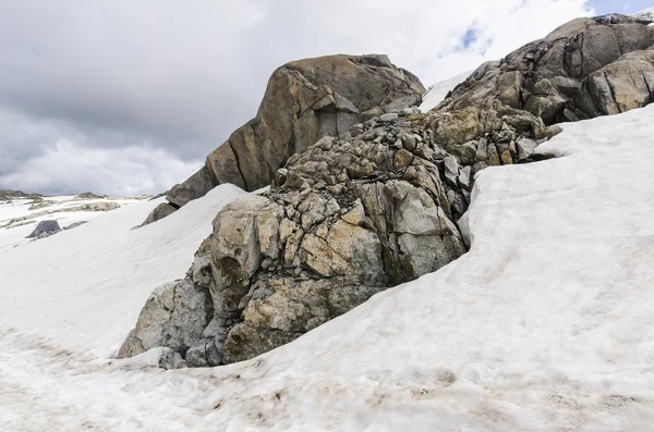 Melting glaciers and rocks on a mountain top at an altitude of 2400 meters in the Italian Alps — Stock Photo, Image