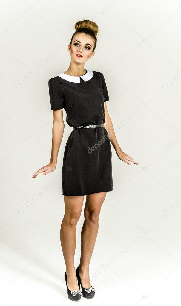 Young cheerful girl in a black dress and goes ape