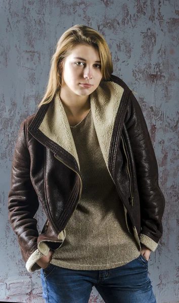 Young beautiful girl with long hair in leather jacket and jeans — Stock Photo, Image