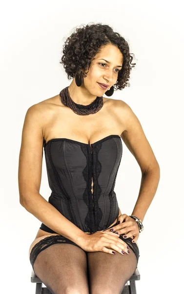 Beautiful young mulatto woman in black lingerie and stockings — Stock Photo, Image