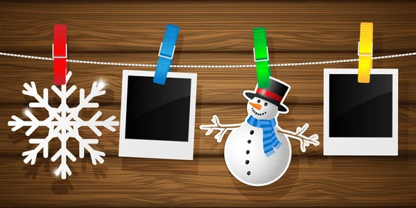 Blank photo frames and snowflakes on a clothesline — Stock Vector