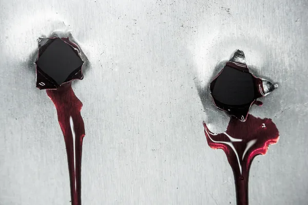 Bloody gunshot holes with blood drips — Stock Photo, Image