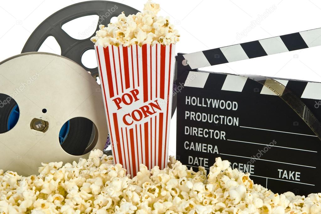 Movie Clapper Board in popcorn with film reel isolated on white