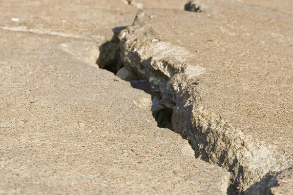 Трещины дорожного бетона близко — стоковое фото