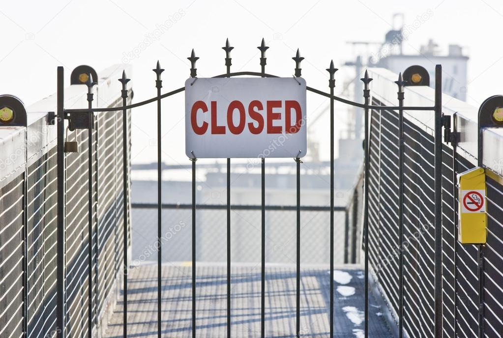 Closed sign on ship yard gate
