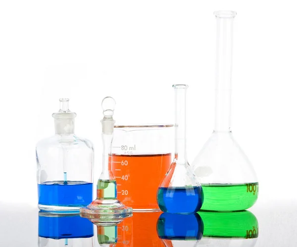 Laboratory glassware with reflections on white background — Stock Photo, Image