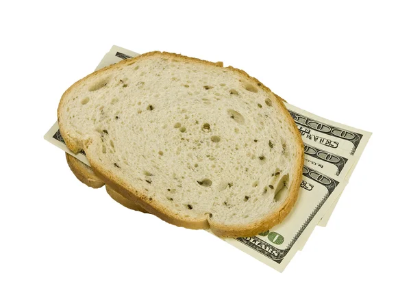 Billetes de cien dólares bajo rebanada de pan blanco — Foto de Stock