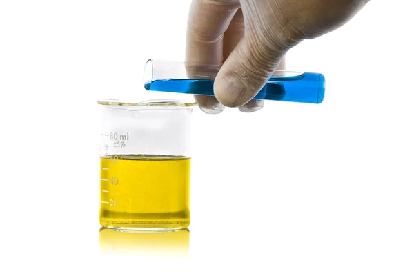 Hand pouring liquid chemicals into flask — Stock Photo, Image