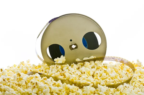 Film reel in popcorn isolated on white — Stock Photo, Image