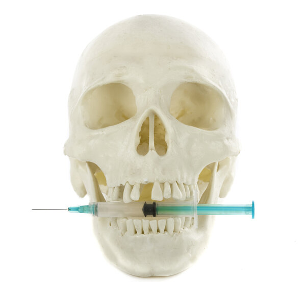 Syringe a skull concept on drugs isolated on white