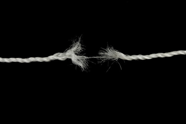 Frayed rope isolated over a black background