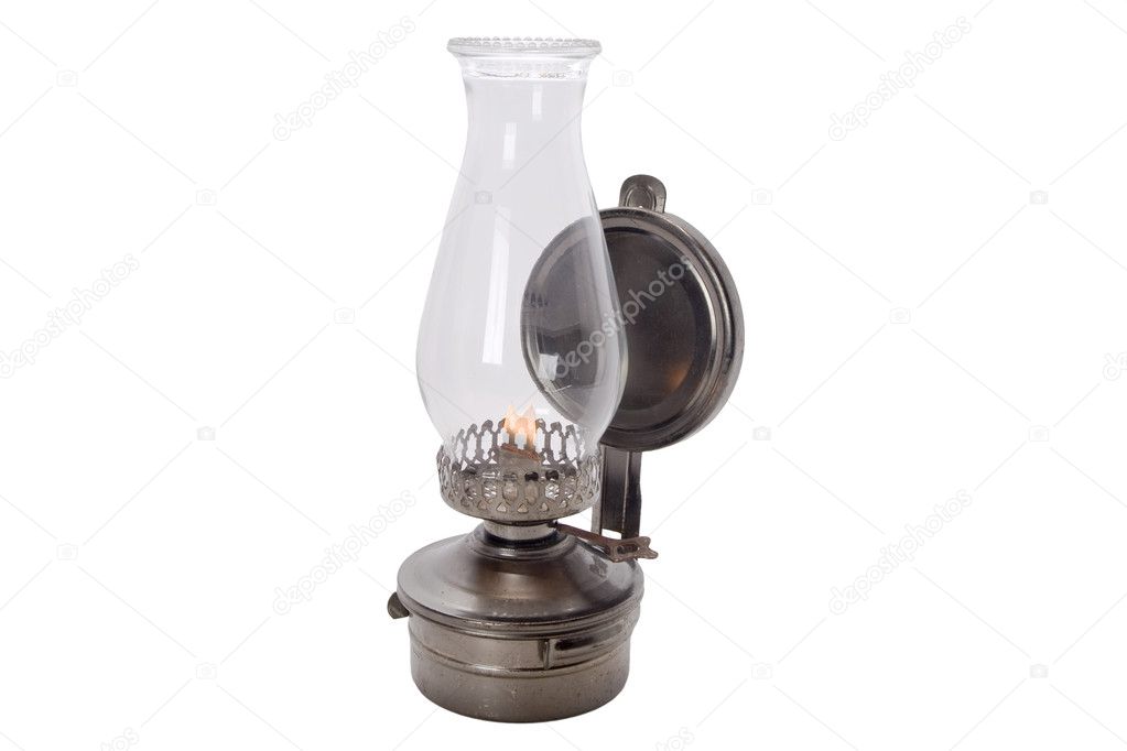 Lit Antique oil lamp isolated on white