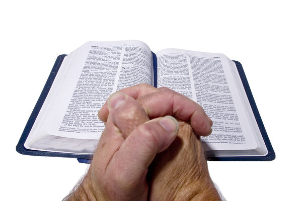 Bible and praying hands