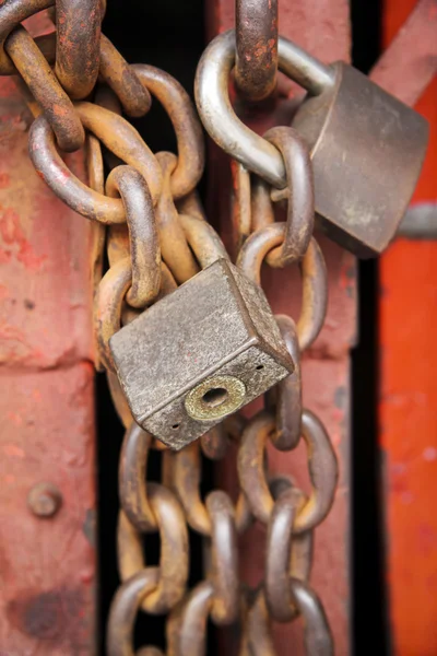 Old rusty metal padlocks on chains — Stock Photo, Image