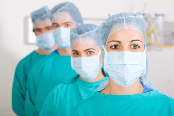 Group of medical surgeons in surgical gowns — Stock Photo, Image