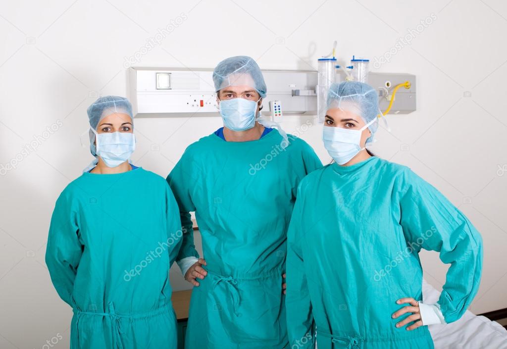 Group of surgeons in surgical gowns in hospital ward