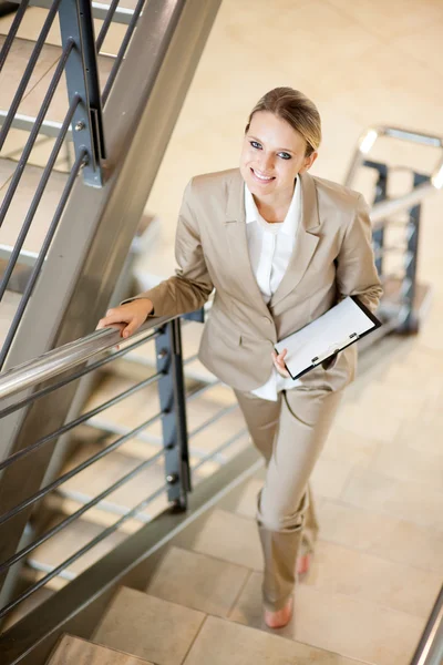 Gorgeous young businesswoman walking up stairs — Stock Photo, Image