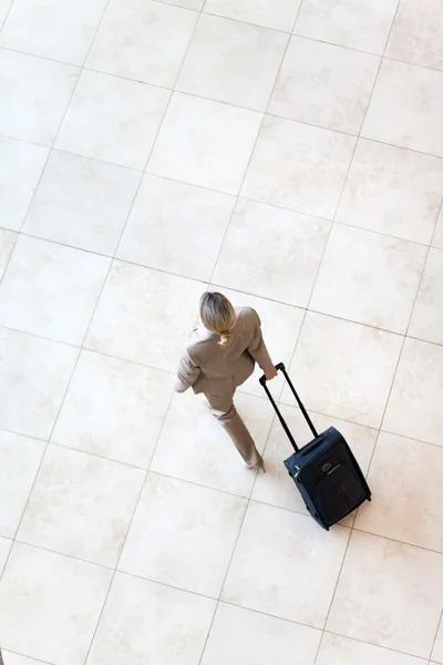 Blick aus der Vogelperspektive auf junge Geschäftsfrau am Flughafen — Stockfoto